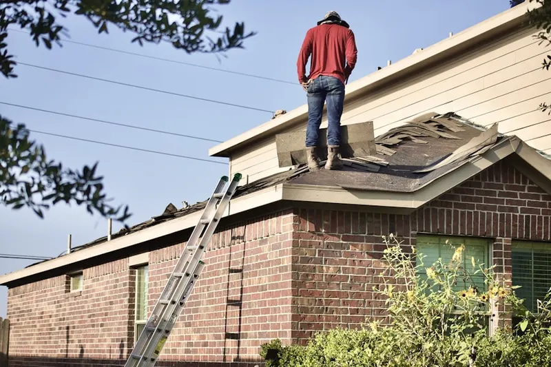 Professional roofer working on a residential roof in Laurel Farms